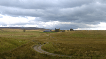 Farm in the Distance with Windfarm Behind