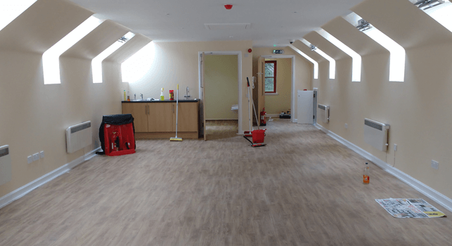 New room, and cloakroom with low sinks visible through the open door